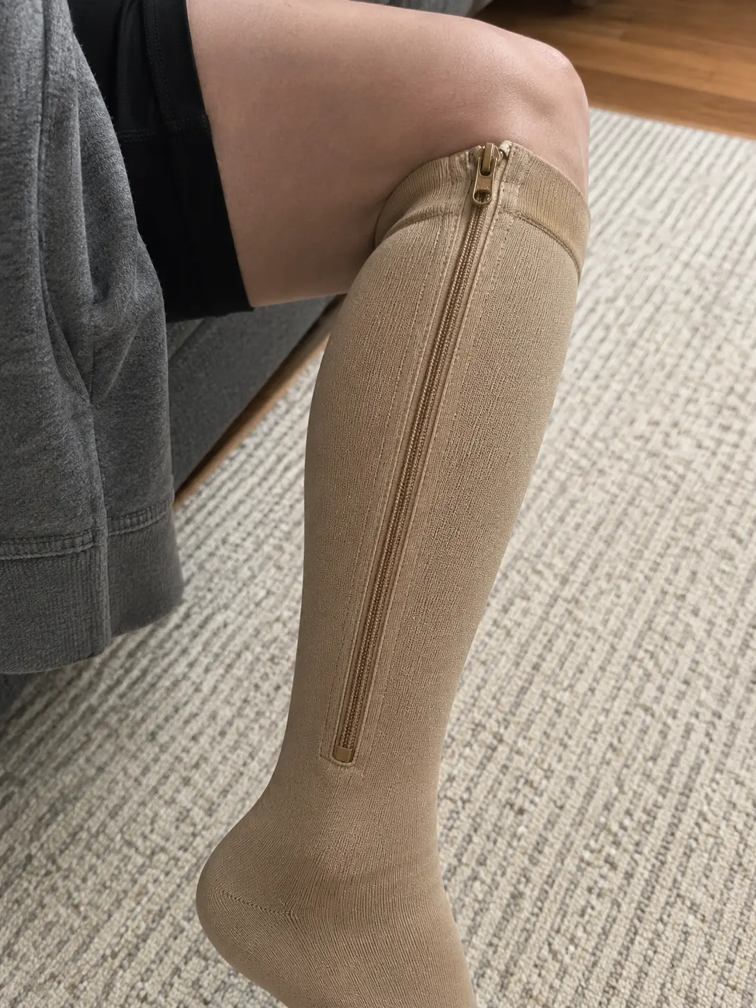 Close-up of the zipper on a beige Easy Zip Compression Sock