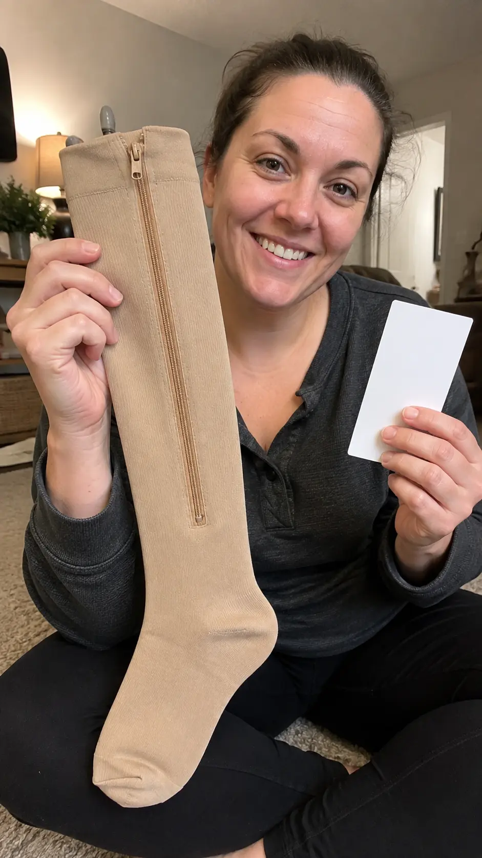 Customer holding one beige Easy Zip Compression Sock