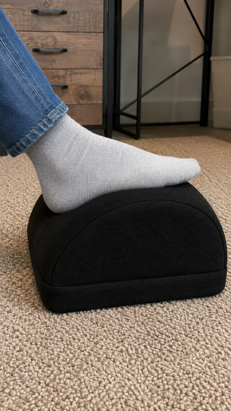 Foot resting on the curved cushion of the Curved Comfort Footrest