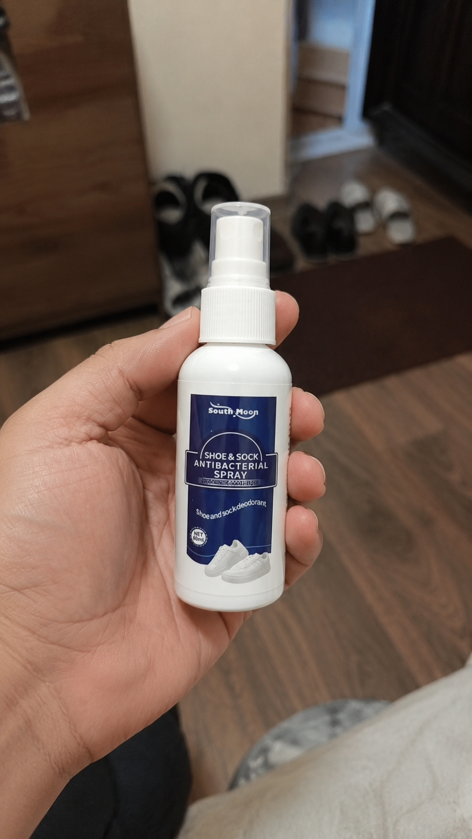 Compact Shoe Reset bottle held in hand