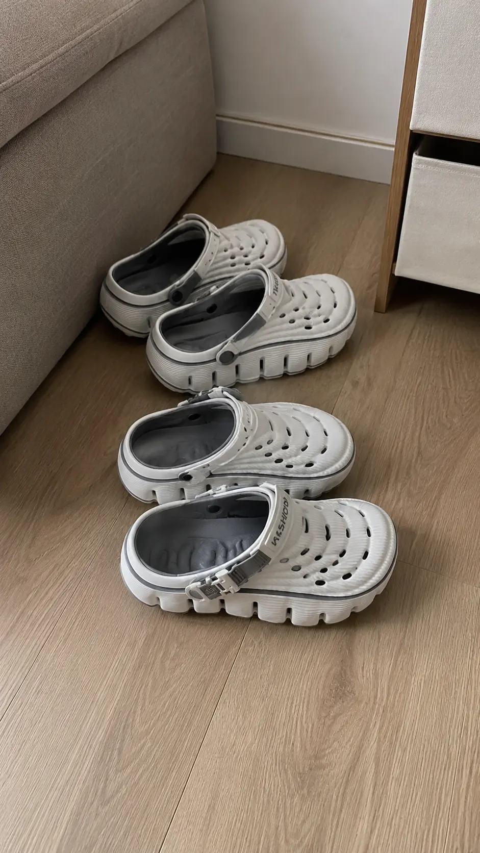 Two pairs of Cloud Recovery Slippers by the sofa