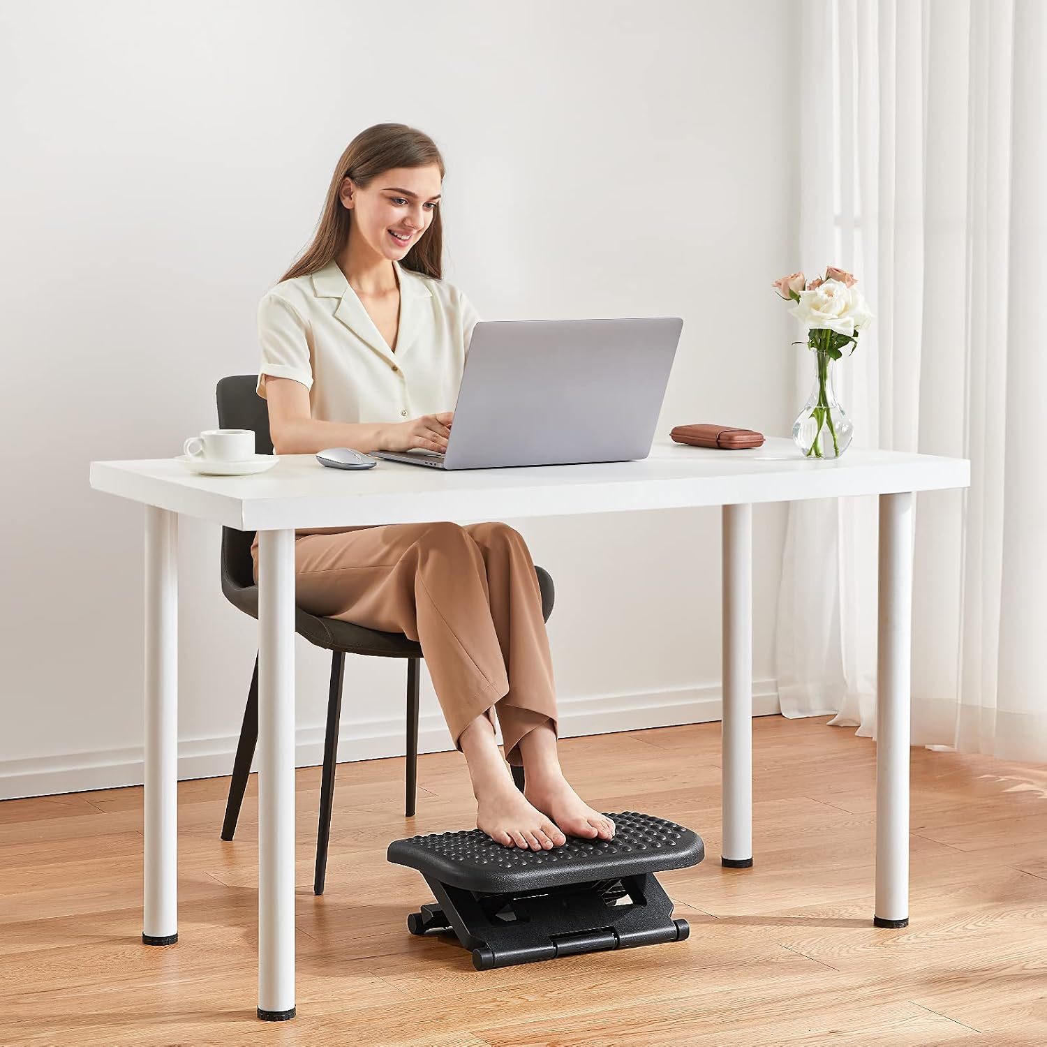 Adjustable footrest used under a desk